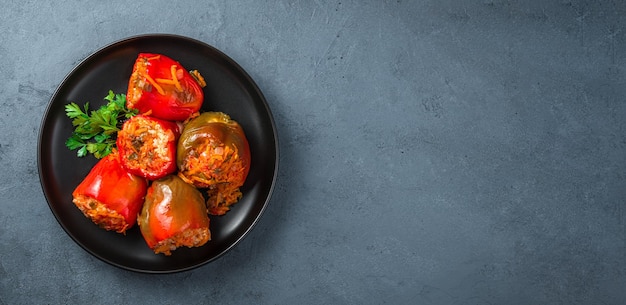 Stuffed bell pepper with fresh parsley on a dark background Healthy food