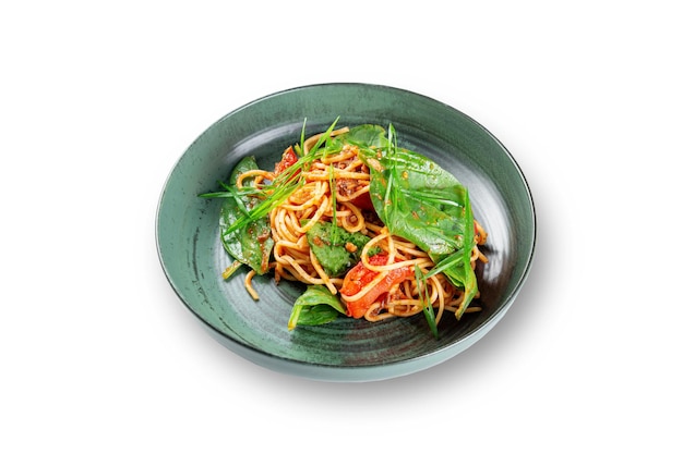 Stuffed Italian spaghetti pasta with spinach and tomatoes on a white isolated background