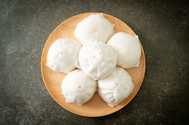 stuffed steamed bun on wood plate - Chinese food style