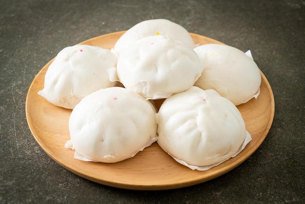 stuffed steamed bun on wood plate - Chinese food style