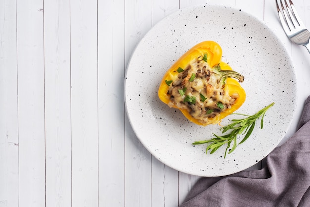 Stuffed sweet pepper with rice, mushrooms, and cheese with herbs