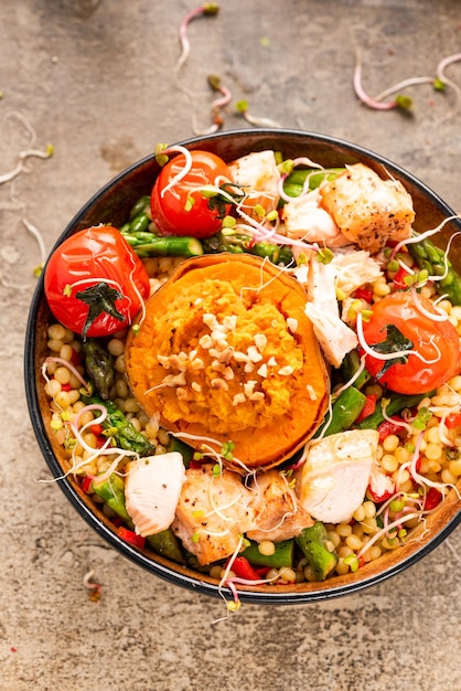 Stuffed Sweet Potato with Couscous and Vegetables in Bowl