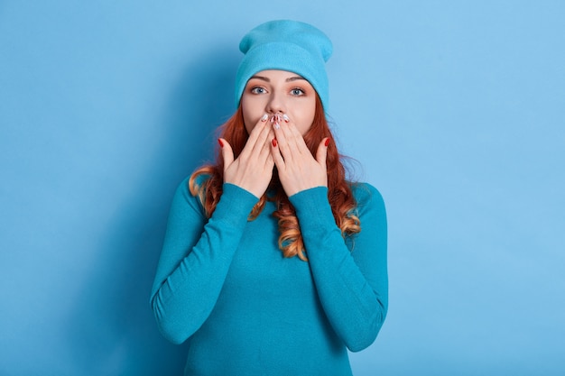 Stunned red haired woman with wavy hair