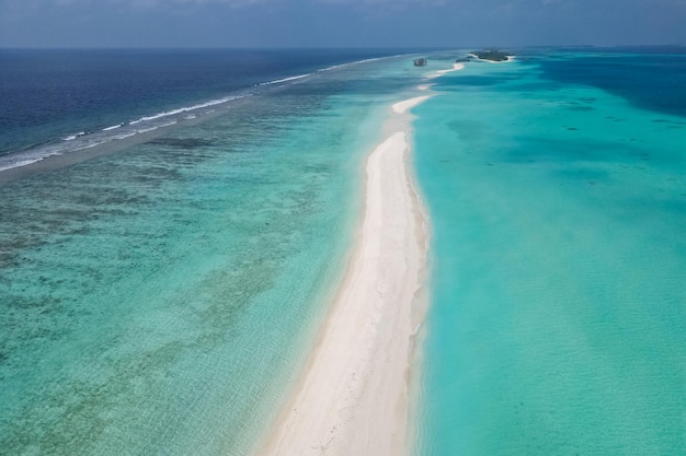 Stunning blue ocean and sandy white island maldives top drone aeral view deserted hidden Maldives beach copyspace for text