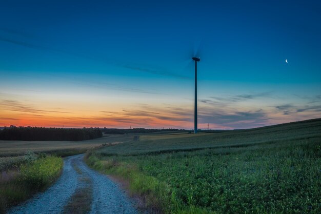 Stunning dusk over field with wind turbines