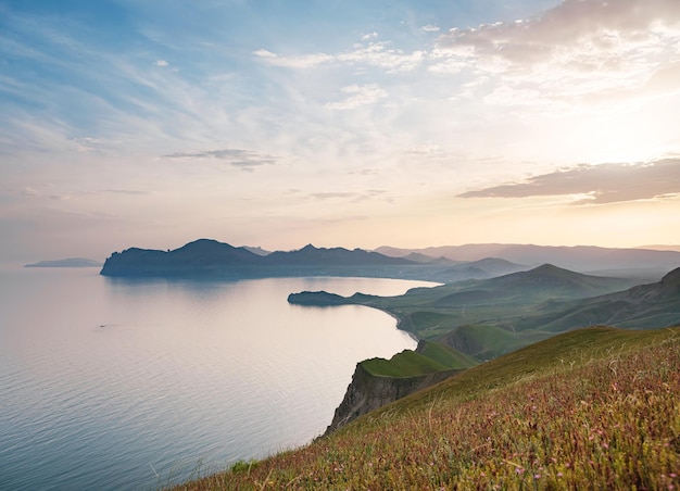 Stunning scenery in the sunset rays of the sea coast and mountains