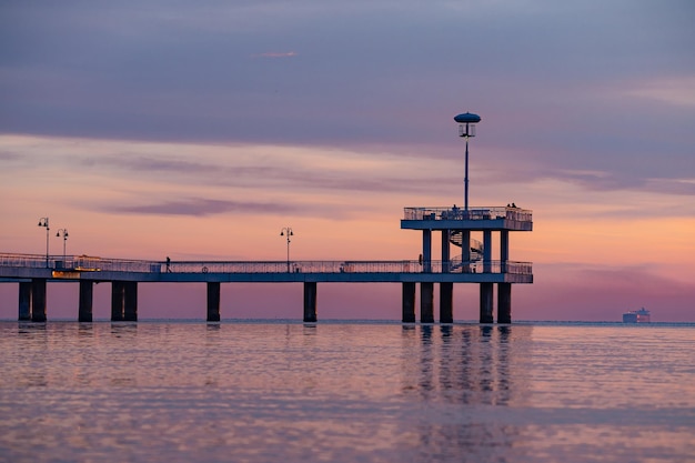 Stunning view of the famous Burgas sea bridge against a dramatic orange and purple sunset sky