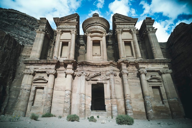 Stunning view from a cave of the Ad Deir Monastery in the ancient city of Petra Jordan Incredible UNESCO World Heritage Site Famous attractions Beautiful monastery in the rock against the sky