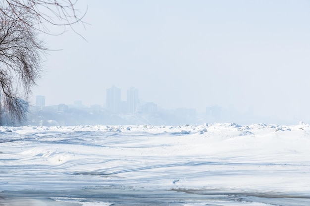 Stunning view of the frozen river covered with chunks of ice and white frosted snow Snowy desert