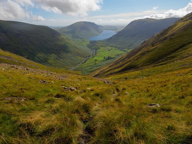 Stunning view of wasdale valley and lake surrounded by mountains under a clear blue sky in the early