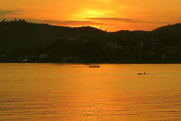 Stunning vivid color of the sunset river landscape with running boats