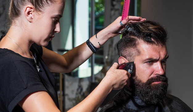 Style in action brutal hipster with moustache making new hairstyle barbershop male trendy hairdo perfect haircut with blade razor barber master cut hair mature hipster with beard at hairdresser