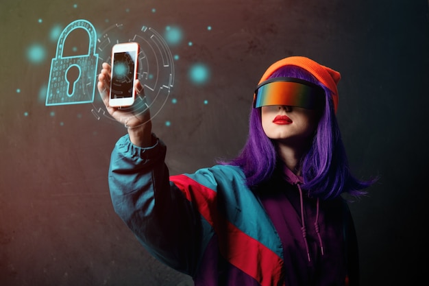 Style hacker woman in VR glasses is with mobile phone