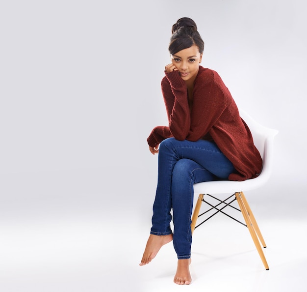 Style simplicity Studio portrait of an attractive young woman sitting on a chair