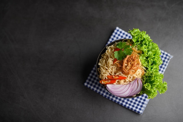 The style still life with noodles in the bowl put on a bluewhite cloth