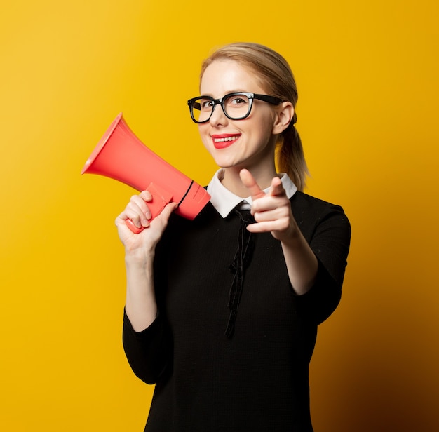 Style woman in black formal clothes with megaphone