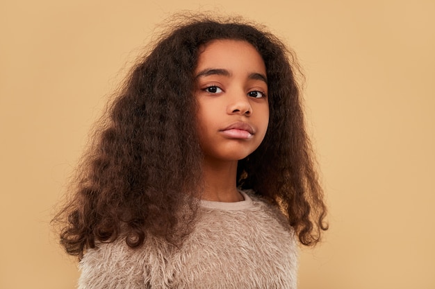 Stylish African American girl in fur garment