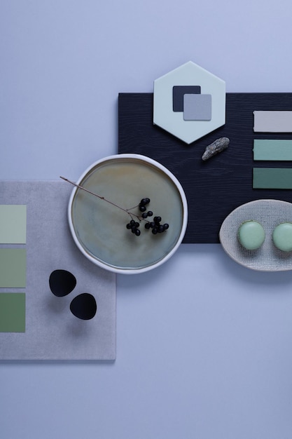 Stylish architect and interior designer moodboard Flat lay composition in grey and green color palette with textile and paint samples panels and tiles Top view Copy space Template