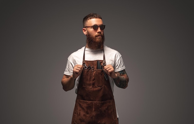 Stylish barber in sunglasses