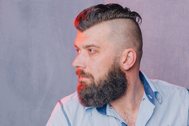 Stylish bearded hipster male. Portrait of a brunette man with a beard.