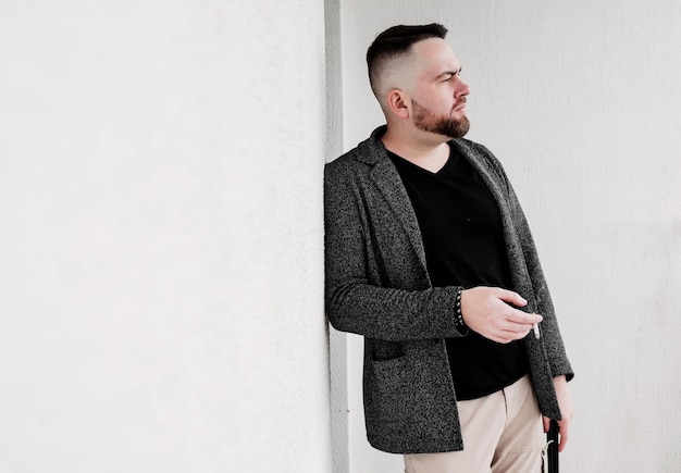 Stylish bearded hipster man smoking cigarette