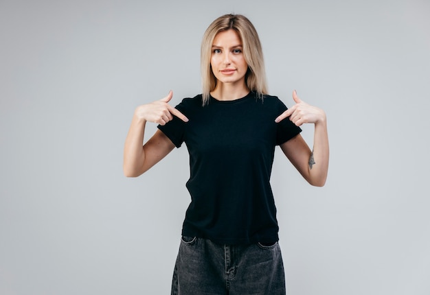 Stylish blonde girl wearing black t-shirt posing