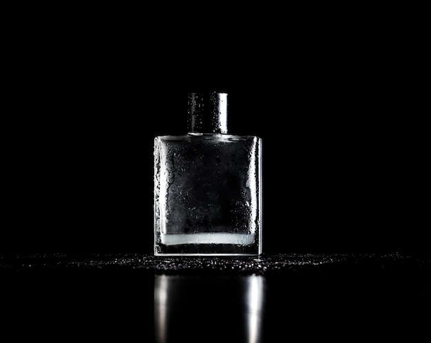 Stylish bottle of perfume on black