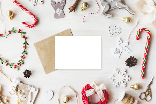 Stylish branding mockup to display your artworks. Cute vintage christmas new year gifts mock up on wooden background. Flat lay top view.