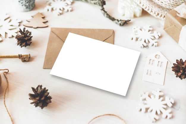 Stylish brending mockup to display your artworks. Cute vintage christmas new year gifts mock up on wooden background.