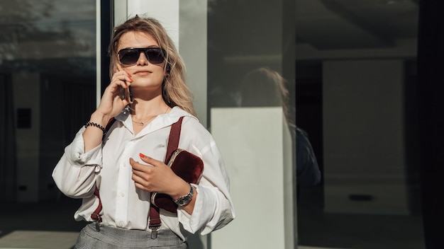 Stylish business woman posing outside