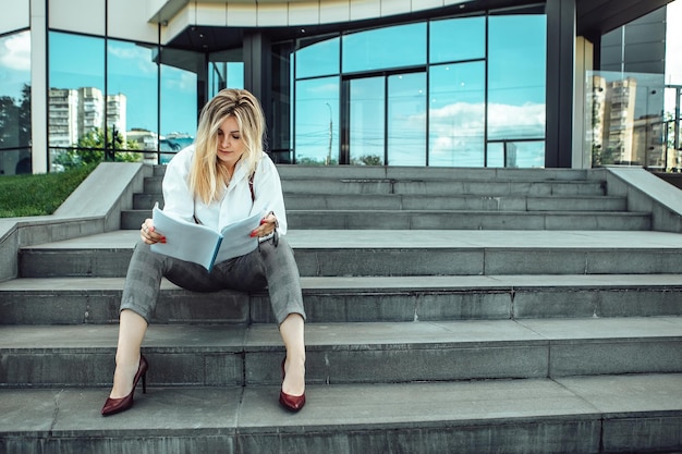 Stylish business woman posing outside