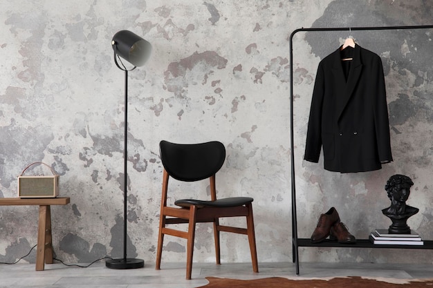 The stylish compostion at living room interior with concrete wall chair hanger with clothes and elegant personal accessories Loft and industrial interior Template xD