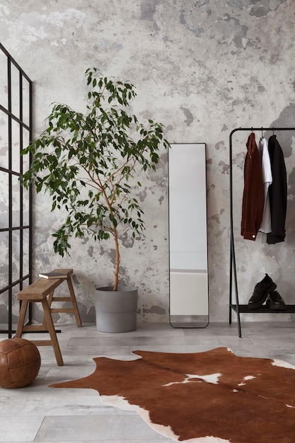 The stylish compostion at living room interior with concrete wall hanger mirror wooden bench and elegant personal accessories Loft and industrial interior Template xD