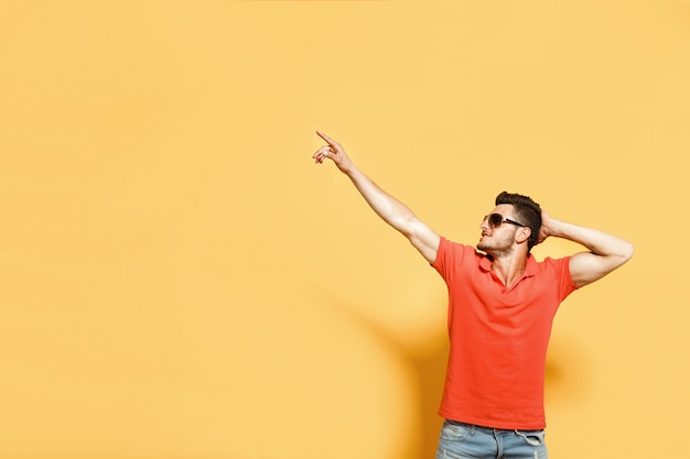 Stylish and confident man on orange