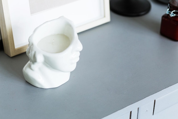 Stylish David bust candle on gray table