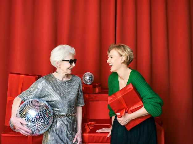 Stylish and fancy senior and mature woman at the party with gift boxes. Party, celebration