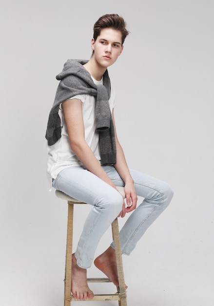 Stylish fashion man model sitting on the chair