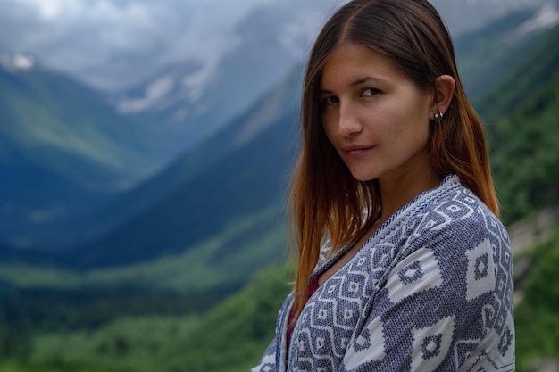 Stylish female hipster walking on top of mountains