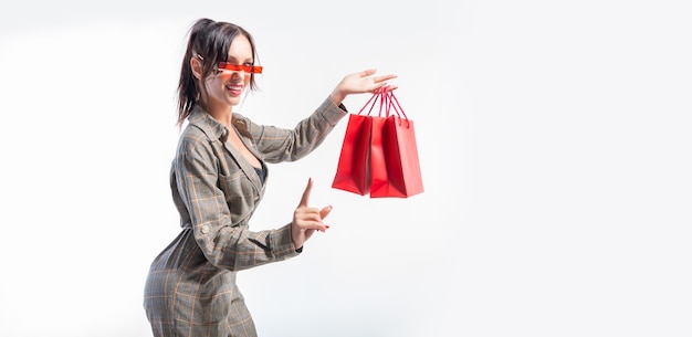 Stylish girl in a suit with packages in her hands