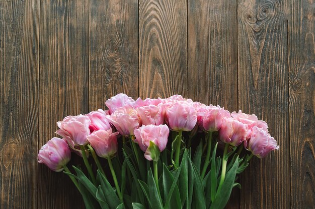 Stylish greeting card Fresh tulips flat lay on wood background Floral Greeting card template with space for text Happy women's day Happy Mother's day Stylish greeting card