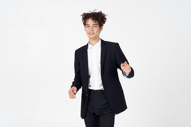 Stylish guy with curly hair and in a jacket shirt pants model