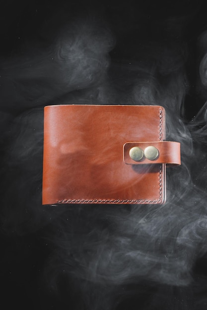 Stylish handmade brown leather wallet on a gray background Product made of genuine leather