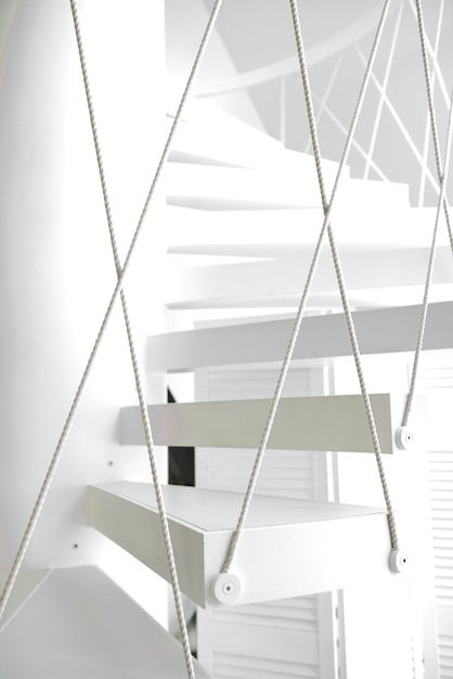 Stylish hanging white spiral staircase, modern style.