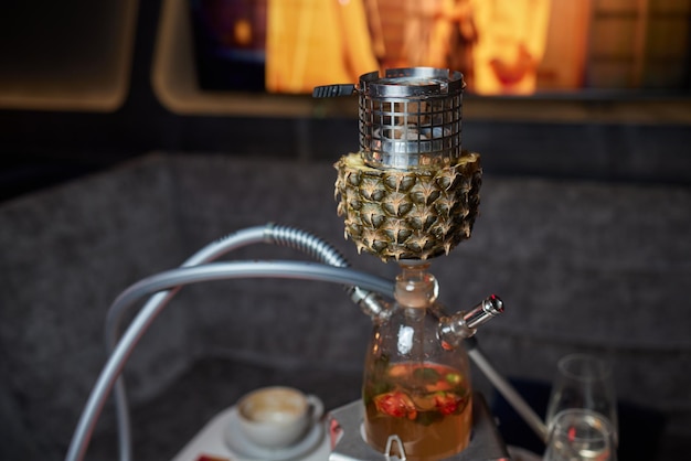 Stylish hookah with the aroma pineapple for relax.Pineapple shisha.Hookah lounge.