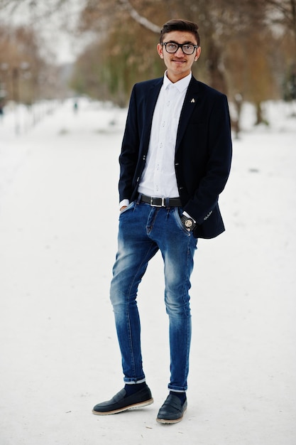 Stylish indian student man in suit and glasses posed at winter day outdoor