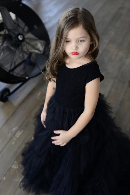 Stylish little girl in black dress