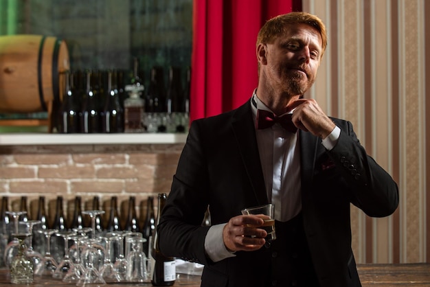 Stylish man drinking whiskey alcohol at bar man at pub