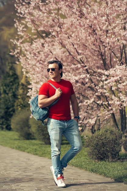 Stylish man ner blooming tree