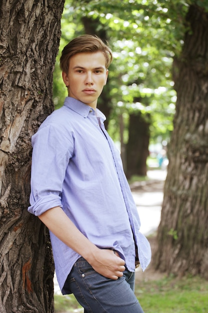 stylish man portrait in summer park.