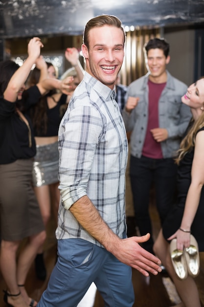 Stylish man smiling on the dancefloor